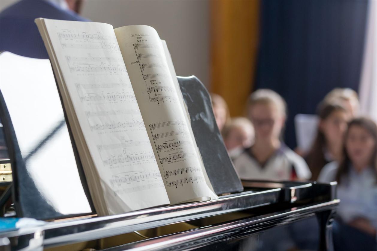 School choir piano with notes foreground and